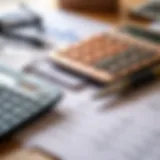 A close-up view of a calculator, financial documents, and a pen on a desk, symbolizing financial planning.